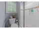 Bathroom featuring toilet, shower, and window with blinds at 13671 Burgess Rd, Middlesex, NC 27557
