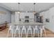 Modern kitchen featuring white cabinets, granite countertops, and a large island with seating at 13671 Burgess Rd, Middlesex, NC 27557