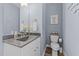 Stylish powder room with dark vanity and modern fixtures at 13671 Burgess Rd, Middlesex, NC 27557