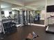 Fitness center with a variety of equipment, including a cable machine and weights at 93 Rosslyn Way, Garner, NC 27529