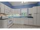 Bright kitchen features white cabinets, and a tiled floor at 3716 Pearl Rd, Raleigh, NC 27610