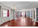 Spacious living room featuring hardwood floors and a view into the dining area at 3716 Pearl Rd, Raleigh, NC 27610