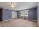 Spacious bedroom with neutral carpeting and double door closet at 3716 Pearl Rd, Raleigh, NC 27610