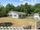 White house with a porch, shed, and white picket fence at 3716 Pearl Rd, Raleigh, NC 27610
