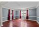 Spacious living room with hardwood floors and large windows at 3716 Pearl Rd, Raleigh, NC 27610