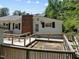 Elevated deck with ramps overlooks a fenced backyard at 3716 Pearl Rd, Raleigh, NC 27610