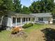 Ranch home with covered porch, ramp, and mature landscaping at 3716 Pearl Rd, Raleigh, NC 27610