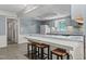 Kitchen with breakfast bar and light blue cabinets at 3716 Pearl Rd, Raleigh, NC 27610