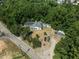 Aerial view showing house, shed, and wooded area at 3716 Pearl Rd, Raleigh, NC 27610