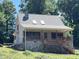 House exterior featuring stone accents, a covered porch, and mature trees at 901 Tanglewood Dr, Siler City, NC 27344