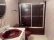 Bathroom with burgundy-colored vanity and shower/tub combo at 901 Tanglewood Dr, Siler City, NC 27344