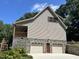 House exterior with two-car garage, stone foundation, and large windows at 901 Tanglewood Dr, Siler City, NC 27344