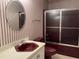 Bathroom with burgundy-colored vanity and shower/tub combo at 901 Tanglewood Dr, Siler City, NC 27344