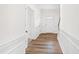 Bright foyer with wainscoting, wood-look flooring, and a staircase at 395 Oak Park Blvd, Youngsville, NC 27596