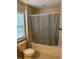 Bathroom with tub and shower, and a window at 506 Averasboro Dr, Clayton, NC 27520