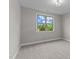 Well-lit bedroom featuring a large window and carpet at 813 Willow Tower Ct # 148, Rolesville, NC 27571