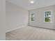 Bright bedroom with neutral carpeting and large windows at 816 Willow Tower Ct # 154, Rolesville, NC 27571