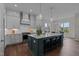 Modern kitchen with white cabinets and a large island at 816 Willow Tower Ct # 154, Rolesville, NC 27571