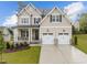 Beautiful two-story house with stone accents and landscaping at 816 Willow Tower Ct # 154, Rolesville, NC 27571