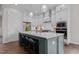 Modern kitchen features an island with seating and white shaker cabinets at 816 Willow Tower Ct # 154, Rolesville, NC 27571