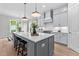 Modern kitchen with gray cabinets, a large island, and stainless steel appliances at 812 Willow Tower Ct # 155, Rolesville, NC 27571
