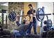 Personal trainer assists member with weight training at 812 Willow Tower Ct # 155, Rolesville, NC 27571
