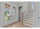 Bright entryway with double doors, hardwood floors, and elegant staircase at 812 Willow Tower Ct # 155, Rolesville, NC 27571