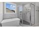 Spa-like bathroom with soaking tub, walk-in shower, and marble tile at 812 Willow Tower Ct # 155, Rolesville, NC 27571