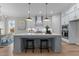 Light and airy kitchen with a large island and modern pendant lighting at 812 Willow Tower Ct # 155, Rolesville, NC 27571