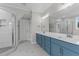 Elegant bathroom with double vanity, blue cabinets, and a walk-in shower at 812 Willow Tower Ct # 155, Rolesville, NC 27571