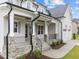 Front entrance with stone accents, porch, and landscaping at 812 Willow Tower Ct # 155, Rolesville, NC 27571