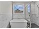 Spa-like bathroom with soaking tub, walk-in shower, and marble tile at 812 Willow Tower Ct # 155, Rolesville, NC 27571