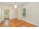 Well-lit bedroom with hardwood floors and a window seat at 1202 Roosevelt Dr, Chapel Hill, NC 27514