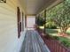 Wooden front porch with railing at 7622 Lindley Mill Rd, Graham, NC 27253