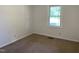 Bright bedroom featuring carpet and a large window at 7622 Lindley Mill Rd, Graham, NC 27253