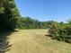 Wooded lot with open grassy area at 7622 Lindley Mill Rd, Graham, NC 27253