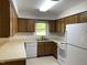 Galley kitchen with wood cabinets and appliances at 7622 Lindley Mill Rd, Graham, NC 27253