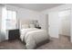 Bright bedroom with striped bedding and closet at 940 Rift Valley Dr, Zebulon, NC 27597