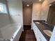 Bathroom with double vanity, granite countertop, and garden tub at 31 Grace Ridge Ct, Benson, NC 27504