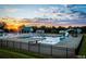 Community pool with diving board and waterslide at sunset at 69 Calluna Dr, Clayton, NC 27520