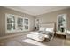 Main bedroom with large windows and a comfy bench at the foot of the bed at 5628 Bella Terra Ct, Wake Forest, NC 27587