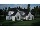Two-story house with white brick and black roof, viewed from the front at 5628 Bella Terra Ct, Wake Forest, NC 27587