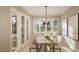 Bright dining room features a large wooden table, six chairs, and access to a porch at 5628 Bella Terra Ct, Wake Forest, NC 27587