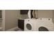 Modern laundry room with washer, dryer, and built-in cabinets at 5628 Bella Terra Ct, Wake Forest, NC 27587