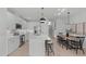 Modern kitchen with white cabinets, marble island, and stainless steel appliances at 600 Rocky Knob Ct, Raleigh, NC 27601
