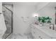 Modern bathroom with double vanity, marble countertops, and a walk-in shower at 600 Rocky Knob Ct, Raleigh, NC 27601