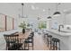 Open concept dining area with wood table and black chairs, adjacent to kitchen and living room at 600 Rocky Knob Ct, Raleigh, NC 27601