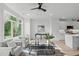 Living room with gray sofas, large windows, and a glass coffee table at 600 Rocky Knob Ct, Raleigh, NC 27601