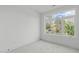 Bright bedroom featuring large windows and gray carpet at 600 Rocky Knob Ct, Raleigh, NC 27601
