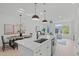 Open concept kitchen with island, white cabinets and marble countertops at 600 Rocky Knob Ct, Raleigh, NC 27601